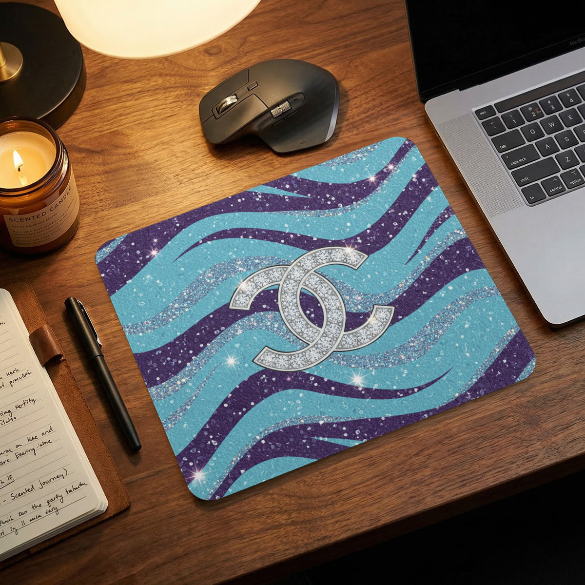 Sparkling double C logo on wavy blue and purple glitter mousepad.