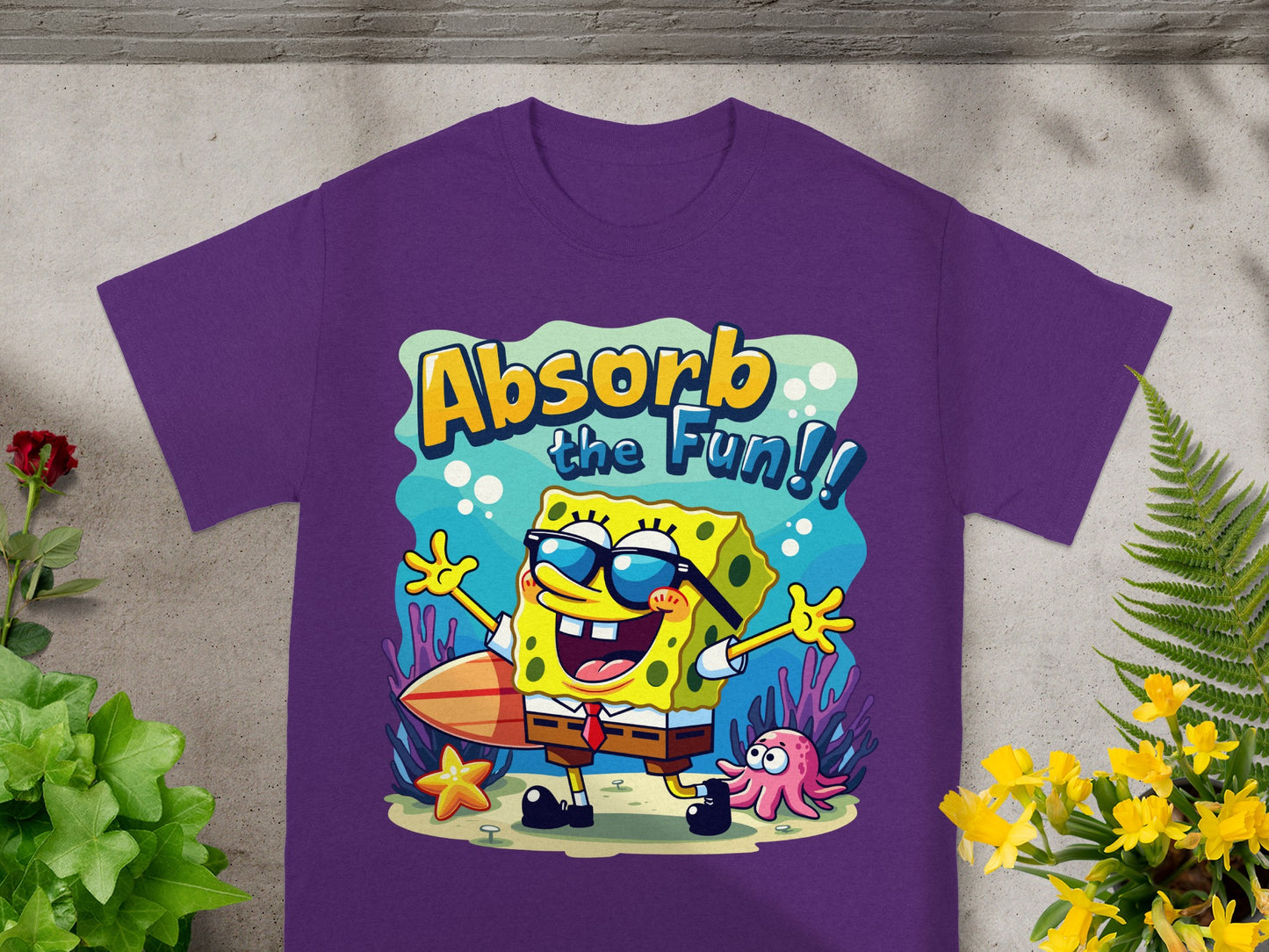 Purple t-shirt with Spongebob Squarepants surfing with text "Absorb the Fun!!"