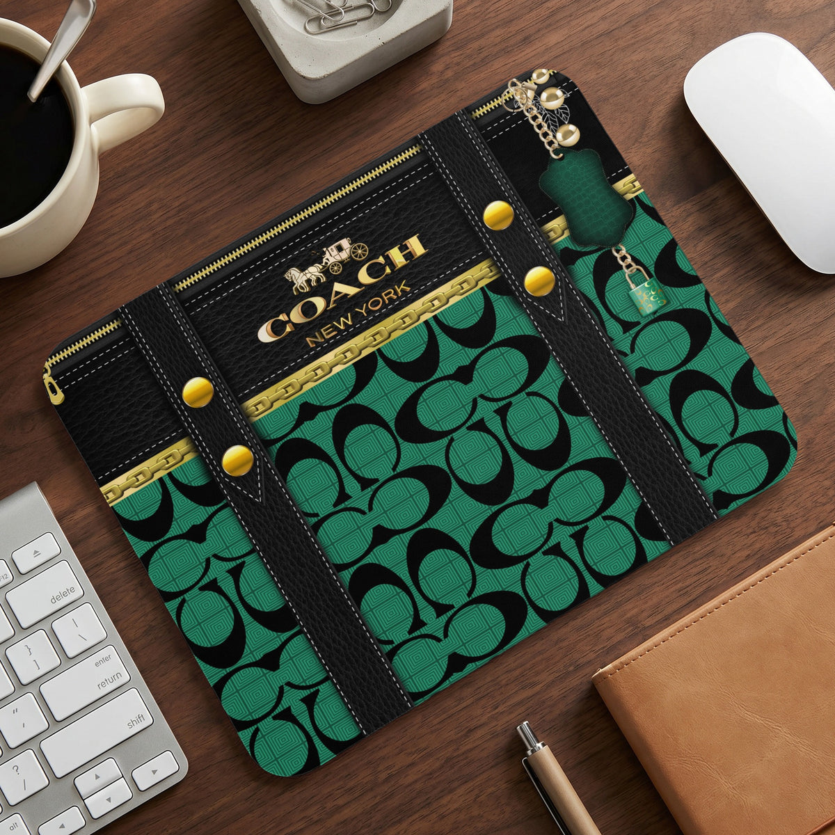 Coach New York mousepad with interlocking Cs pattern and gold hardware details.