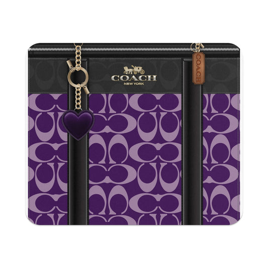 Coach wallet with signature C pattern and purple heart charm.