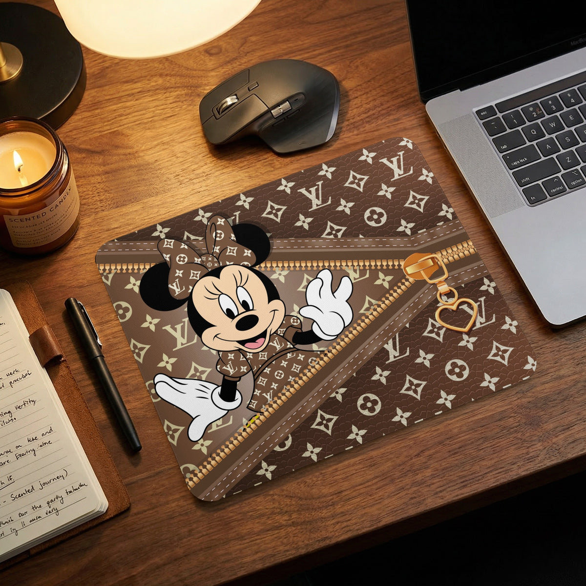 Minnie Mouse mousepad with brown monogram pattern and gold zipper detail.
