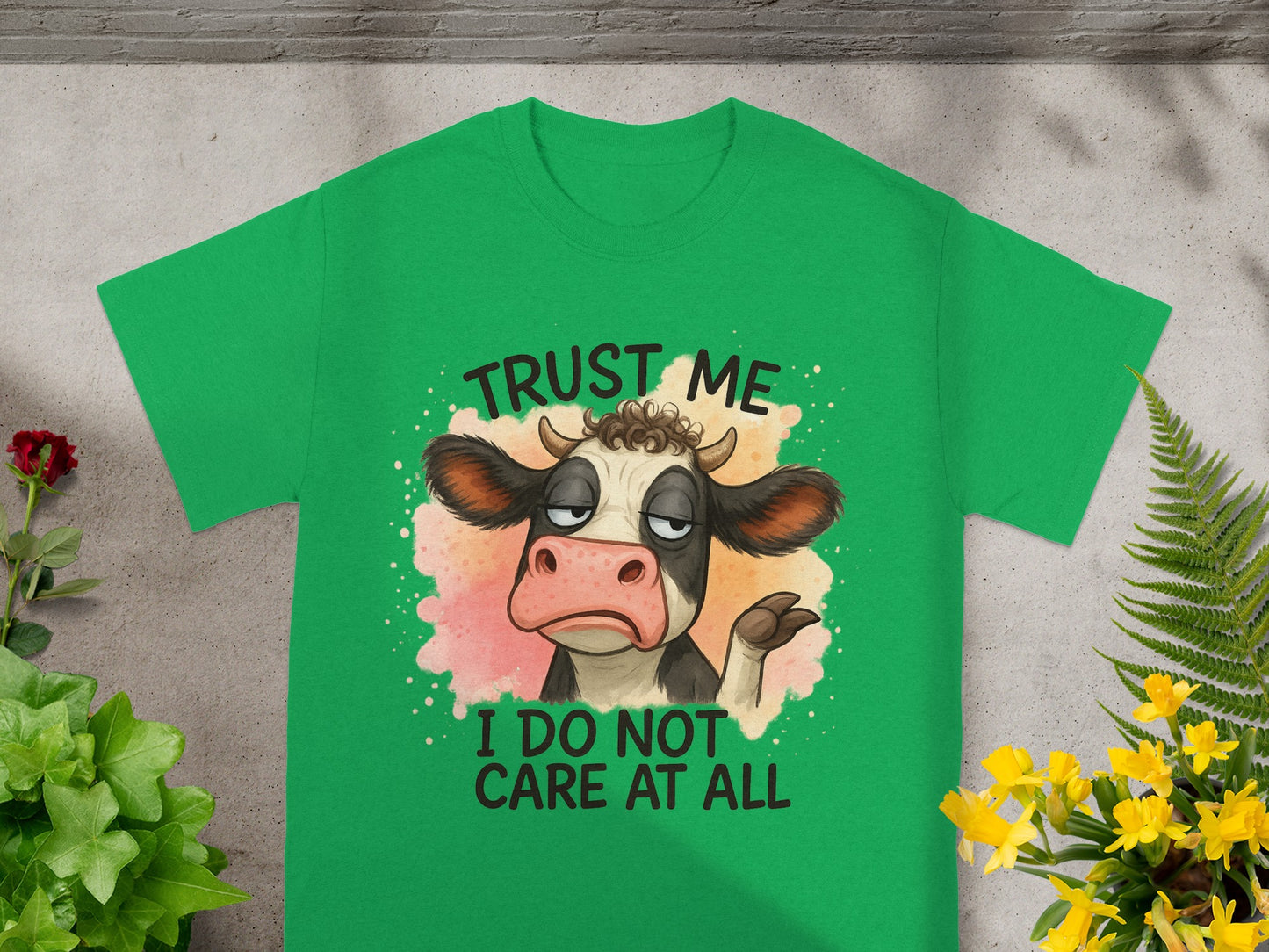 Green t-shirt with cartoon cow and text "Trust me, I do not care at all."