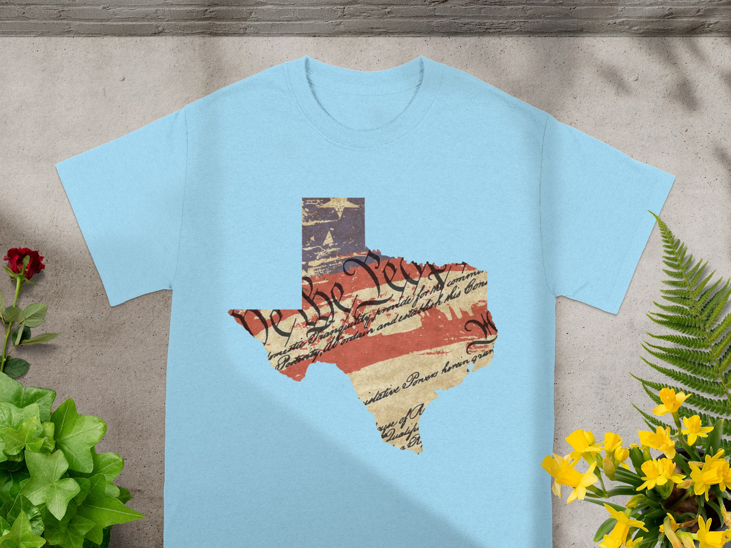 Light blue t-shirt with Texas outline graphic featuring US Constitution text and flag.