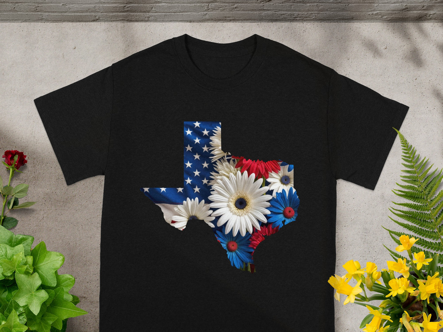 Black t-shirt with Texas map design featuring American flag and patriotic flowers.
