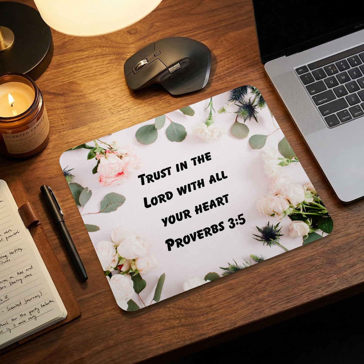 Floral mouse pad featuring the text Trust in the Lord with all your heart Proverbs 3:5 on a wooden desk.