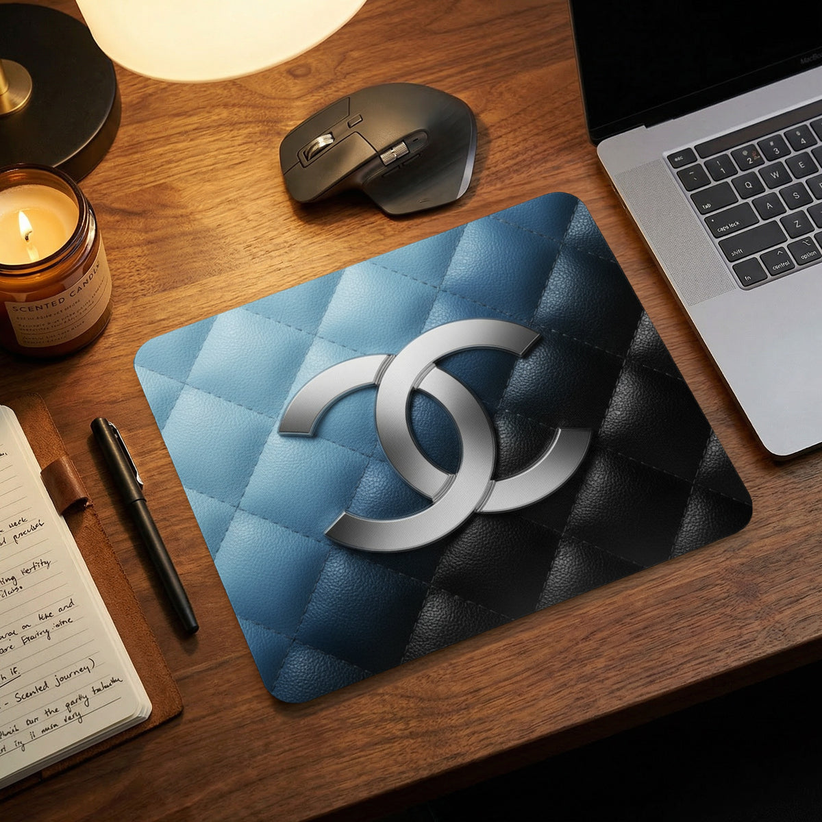 Mousepad with quilted blue and black pattern and interlocking silver double C logo.