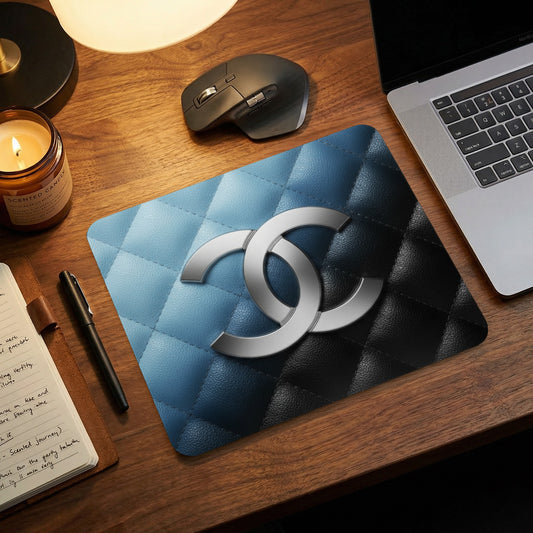 Mousepad with quilted blue and black pattern and interlocking silver double C logo.