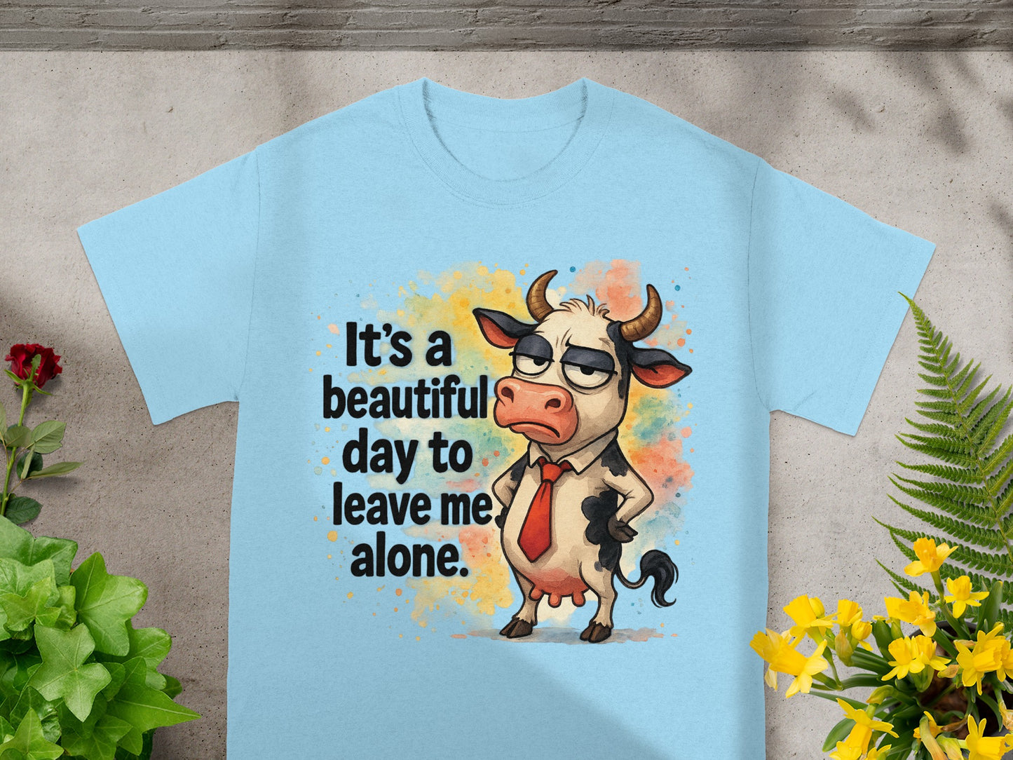 Light blue t-shirt with cartoon cow graphic saying "It's a beautiful day to leave me alone."