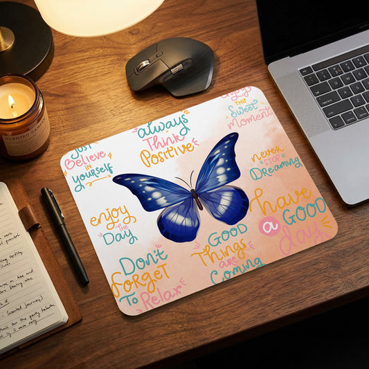 Mousepad with a blue butterfly and motivational text phrases.