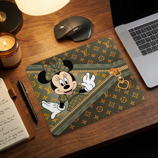 Minnie Mouse on a green mousepad with a faux zipper and monogram pattern.