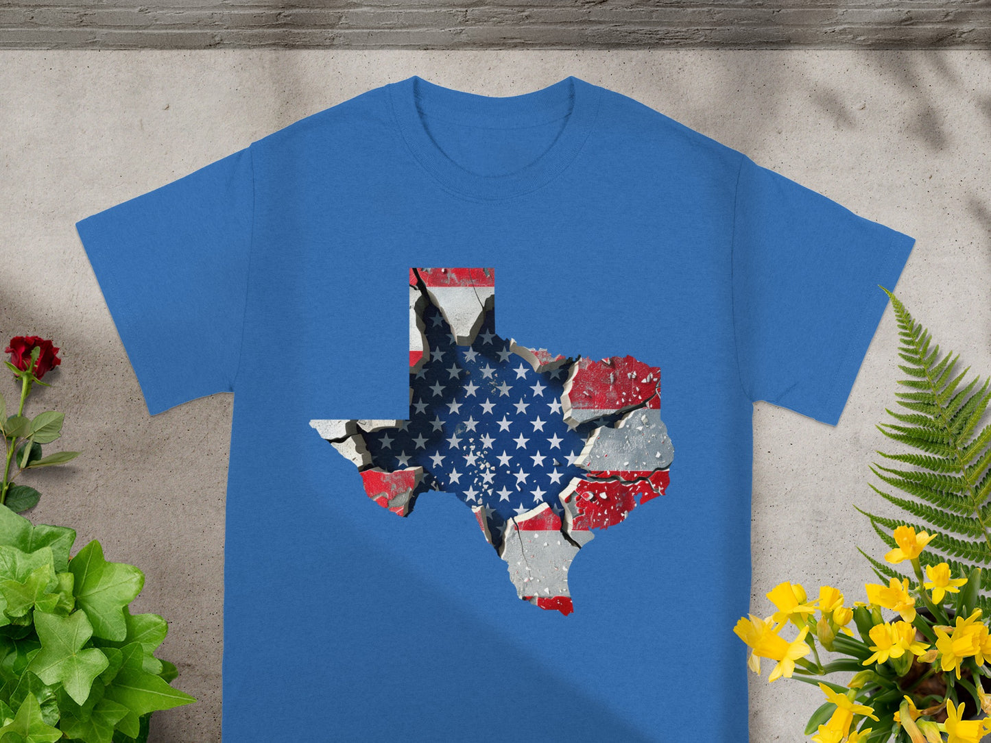 Blue t-shirt with Texas shape graphic featuring American flag design and cracked effect.