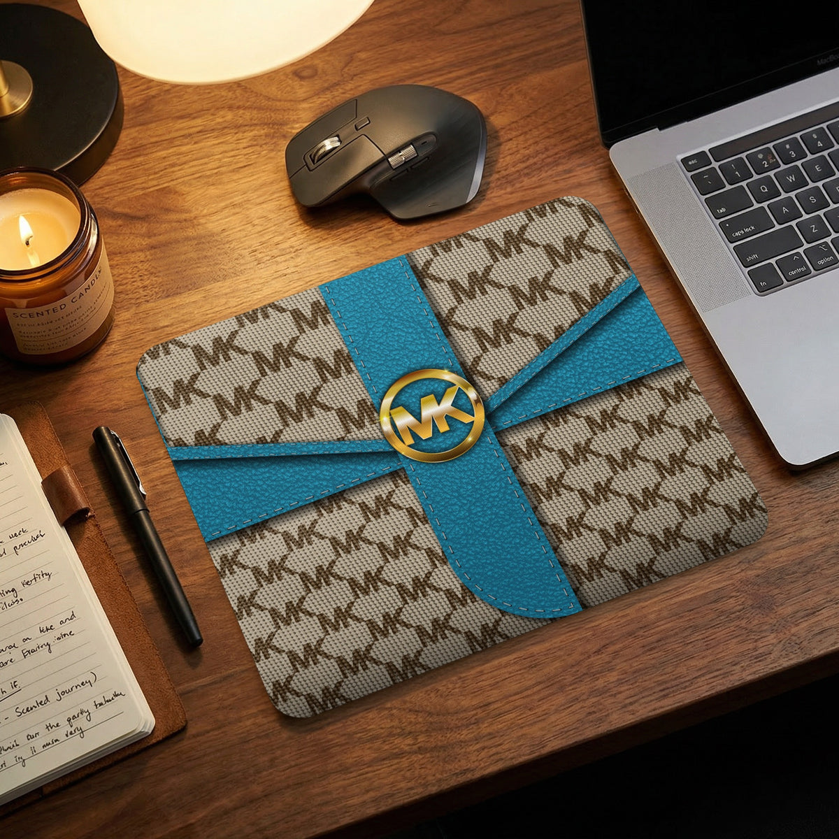 Michael Kors patterned mousepad with gold logo and blue straps.