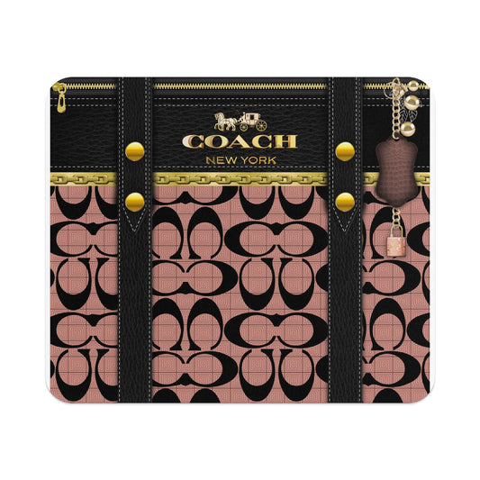 Coach pattern with black leather straps, gold chain, and a small padlock charm.