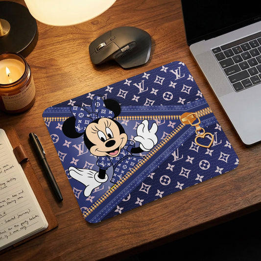 Minnie Mouse with a Louis Vuitton pattern mousepad on a desk.
