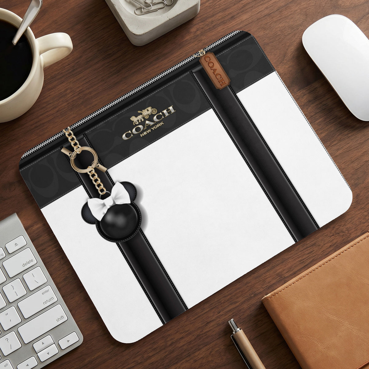 Coach mousepad with black and white design and Mickey Mouse charm.