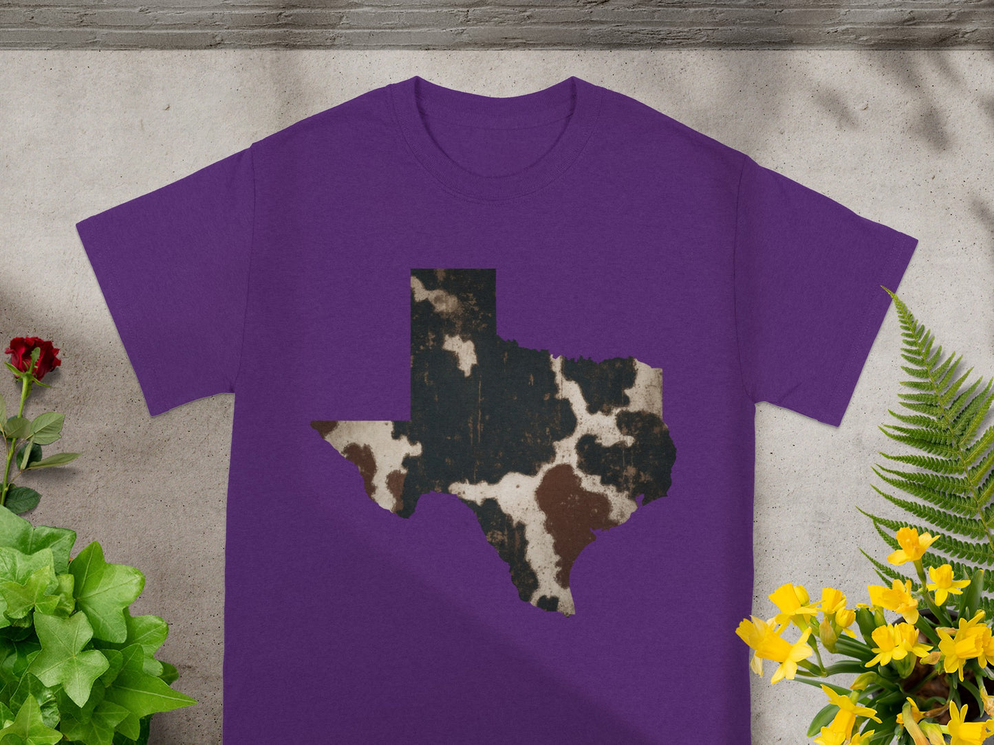 Purple t-shirt with Texas outline in cowhide pattern.