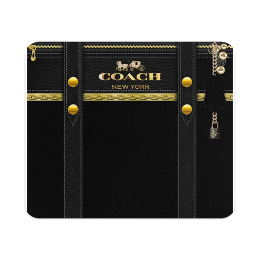 Coach New York logo on black textured material with gold hardware and charms.