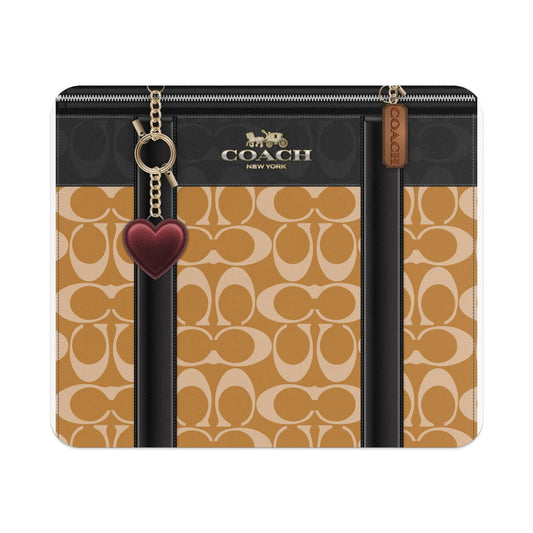 Coach New York bag with signature print and heart charm.