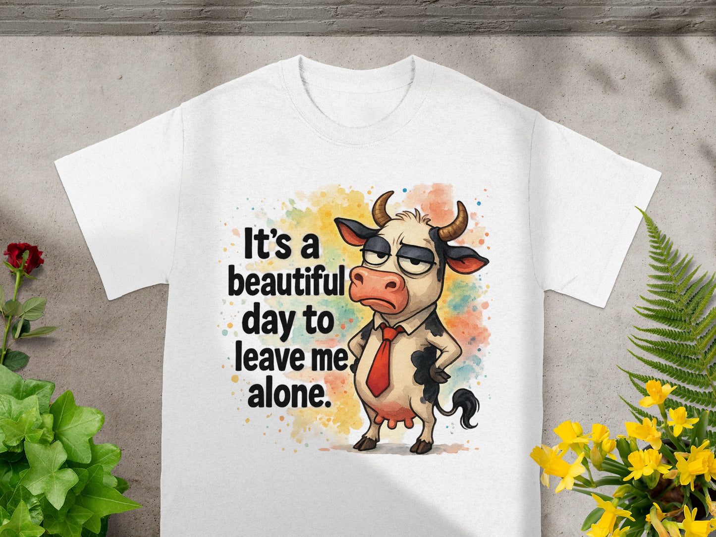 White t-shirt with a grumpy cartoon cow wearing a tie and the text "It's a beautiful day to leave me alone."