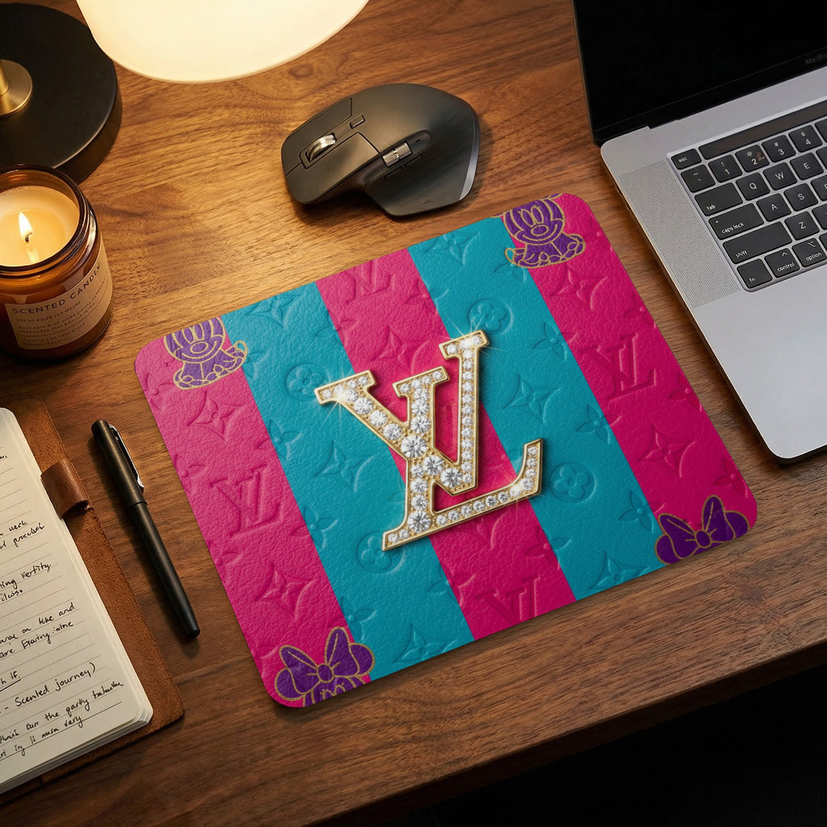 Pink and teal mousepad with debossed logos and Mickey Mouse ears.
