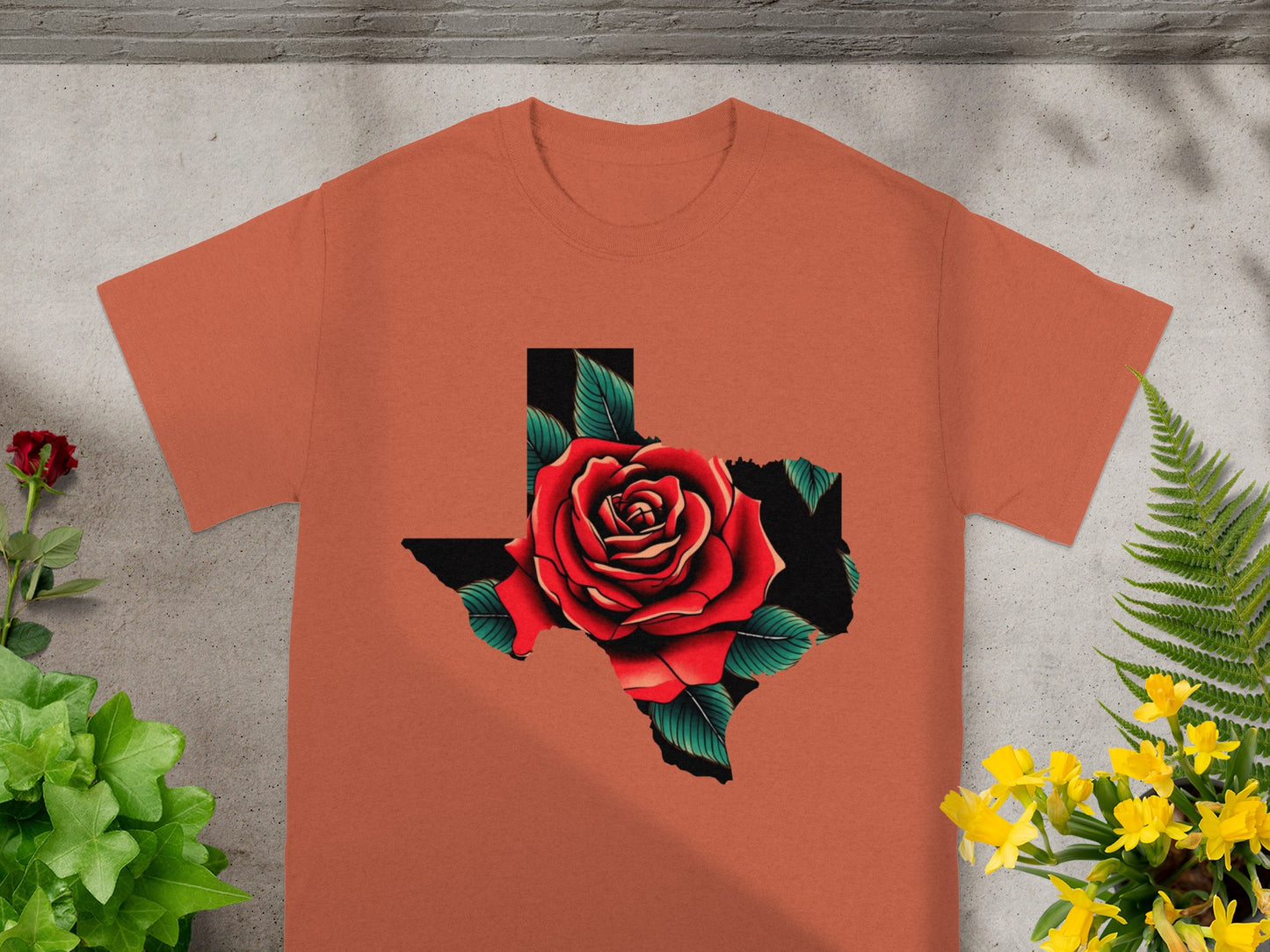 Orange t-shirt with a red rose inside the outline of Texas.