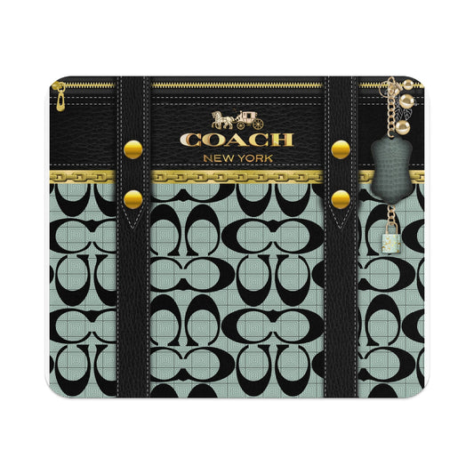 Coach New York black leather wallet with signature pattern and keychain.