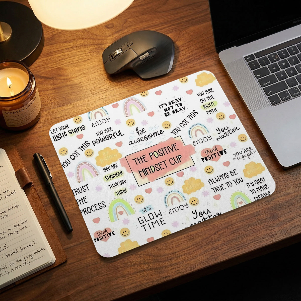 Mousepad with "The Positive Mindset Cup" and motivational phrases with rainbows and smiles.
