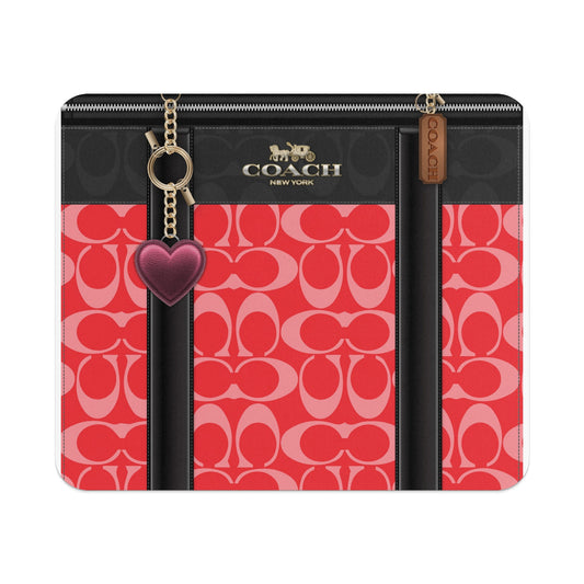 Coach wallet with red C pattern, gold chain, and heart charm.
