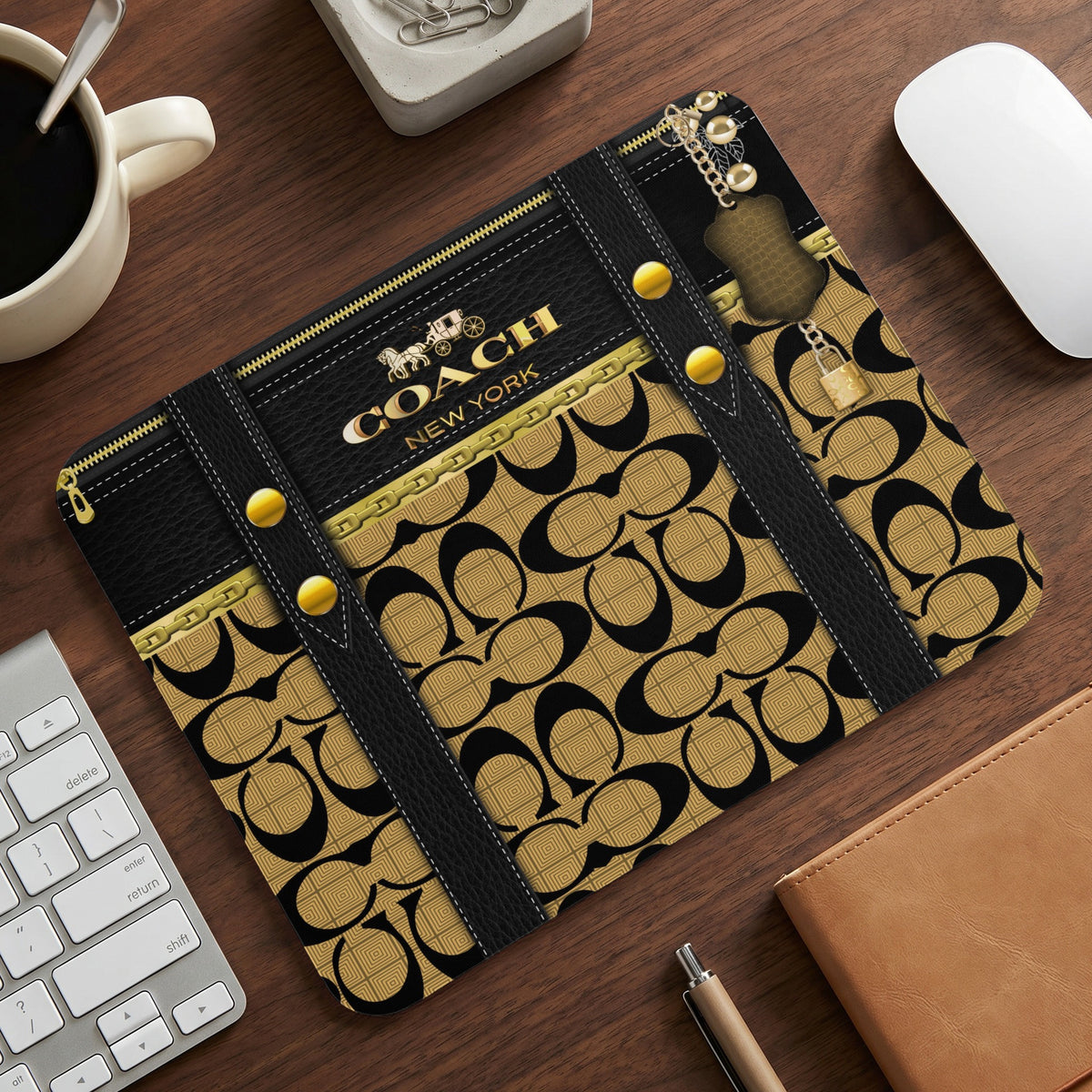Coach New York mousepad with black and gold logo pattern.