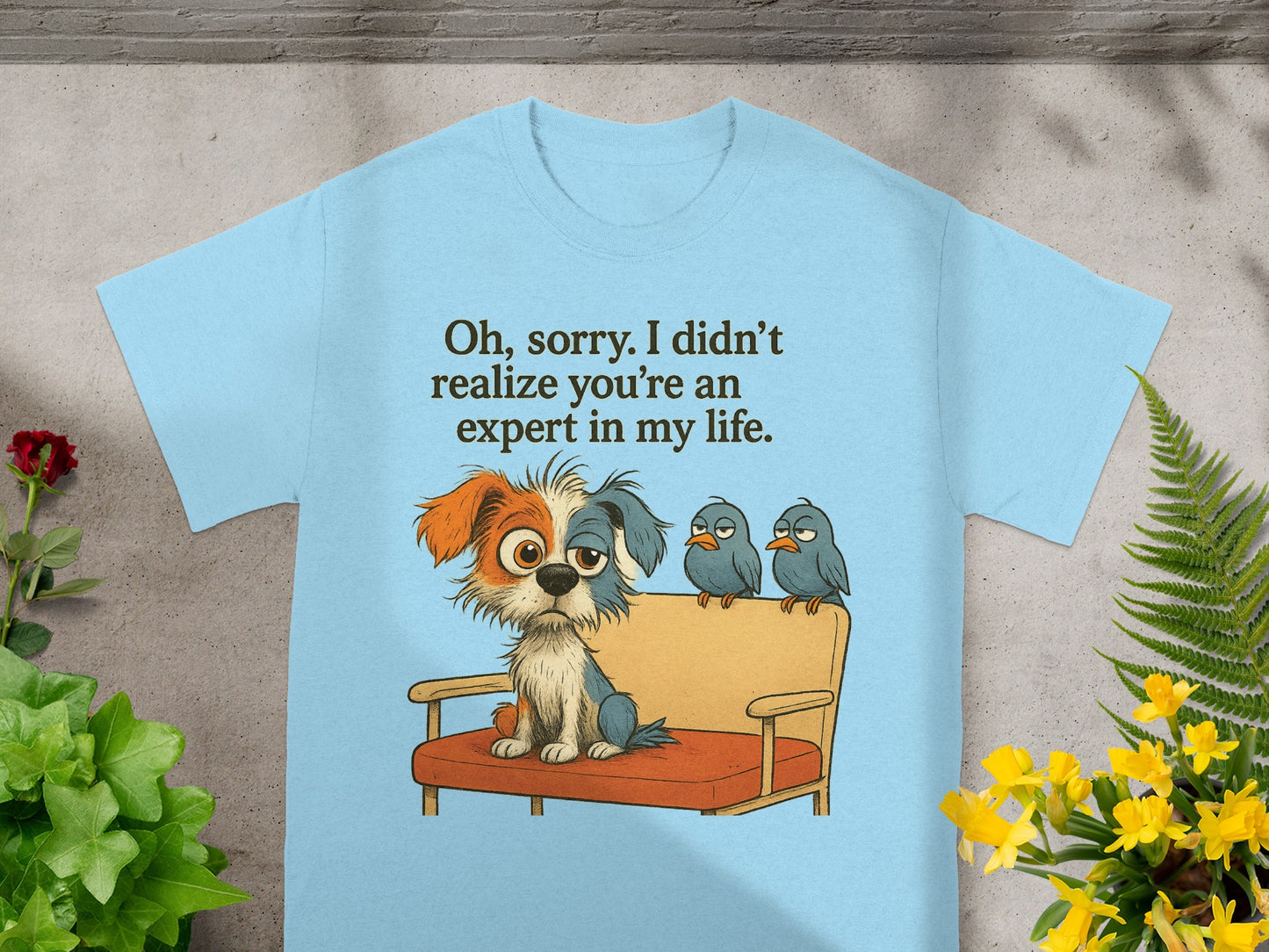 Light blue t-shirt with a cartoon dog and three birds on a couch with text.