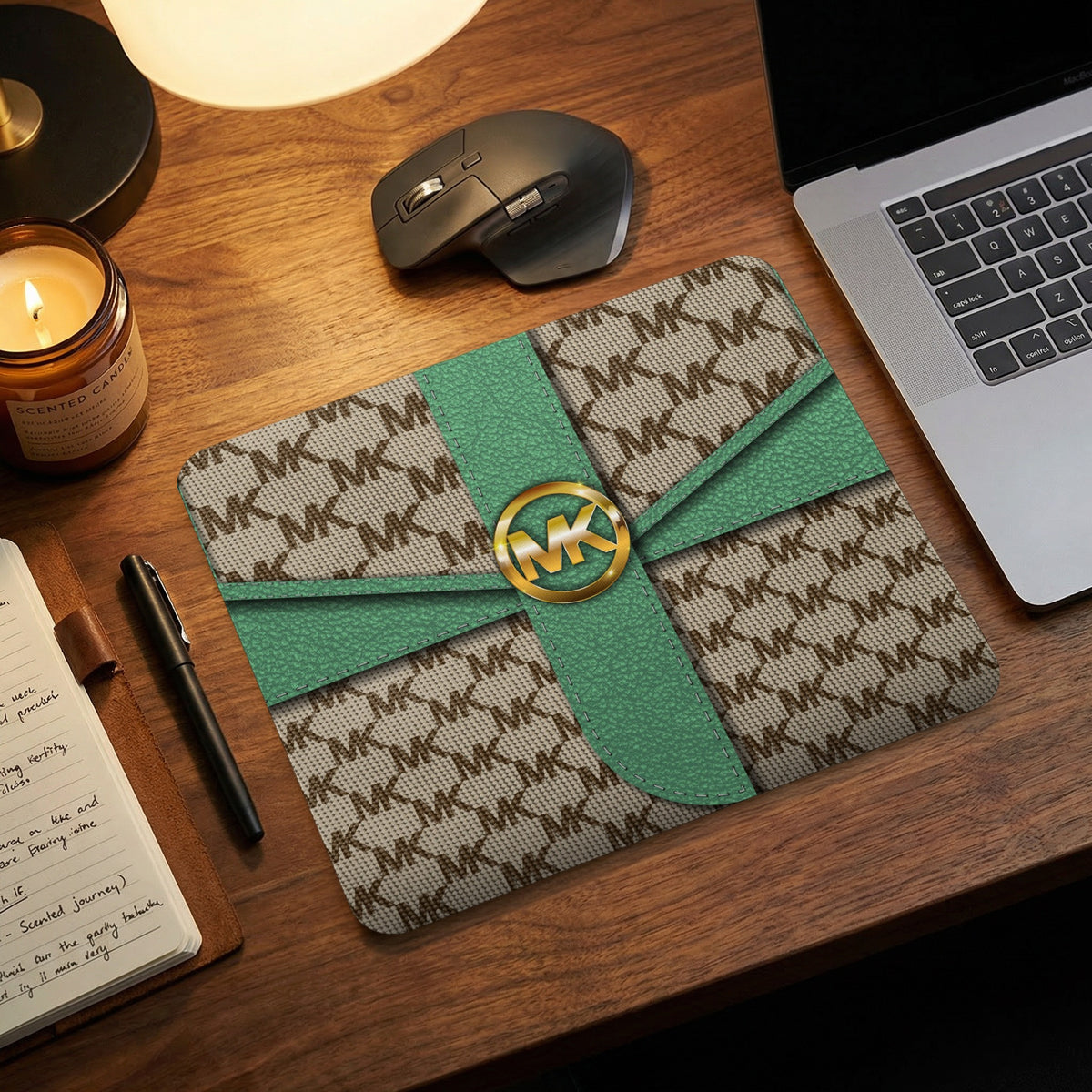Michael Kors logo mousepad with MK pattern and green ribbon accent.