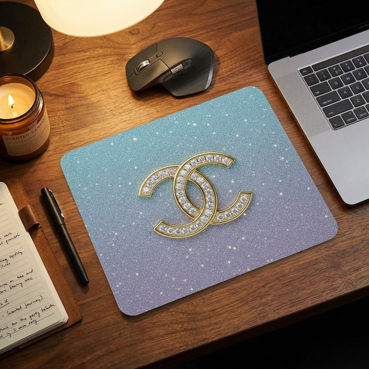 Sparkling gradient mousepad with intertwined gold and diamond logo.