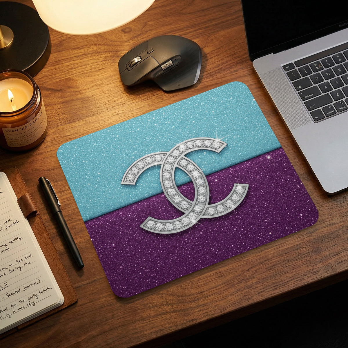 Sparkling double C logo on glittery turquoise and purple mousepad.