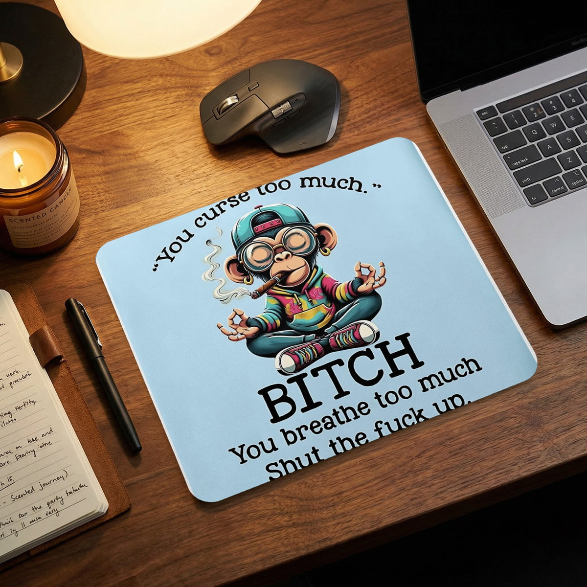 A light blue mousepad featuring a cartoon monkey smoking a cigar and meditating, with humorous text.