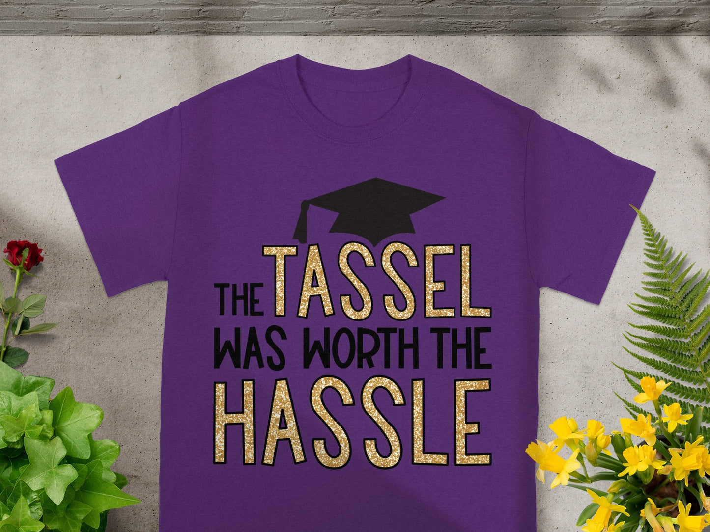 Purple t-shirt with "The Tassel Was Worth the Hassle" text and graduation cap.
