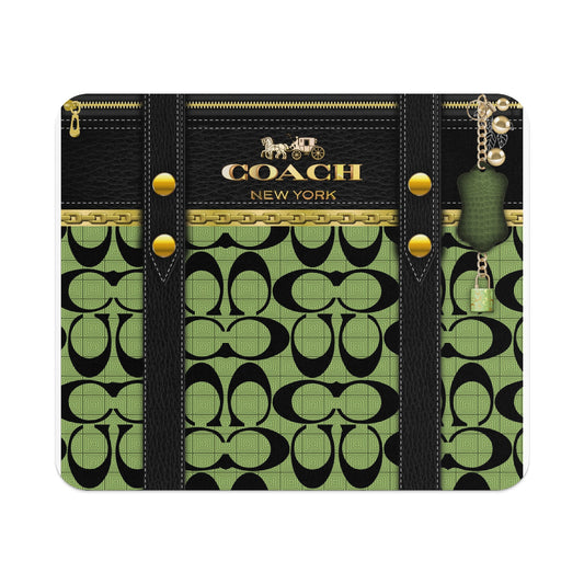 Coach wallet with black leather, gold chain, green signature pattern, and keychain lock.