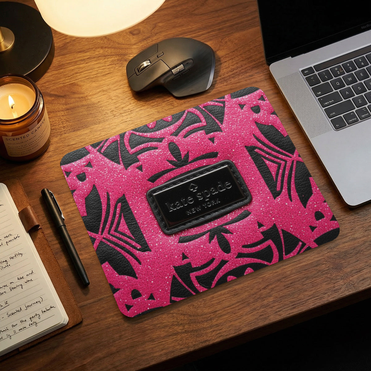Kate Spade New York mousepad with pink glitter and black abstract pattern.