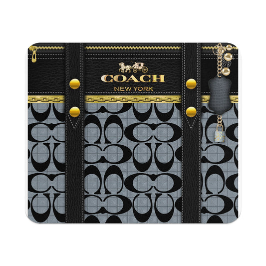 Coach New York pattern with leather straps, gold zipper, and keychain.