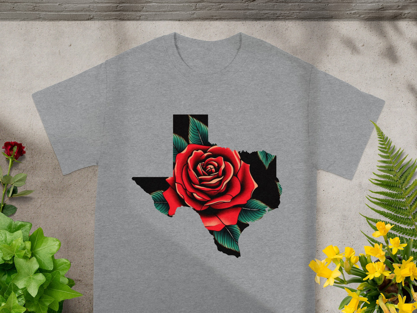 Grey t-shirt with a Texas outline filled with a red rose and green leaves.