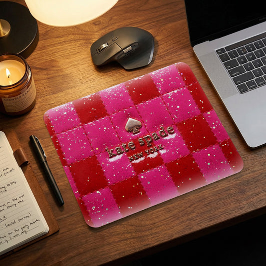 Kate Spade New York mousepad with pink and red checkered glitter pattern.