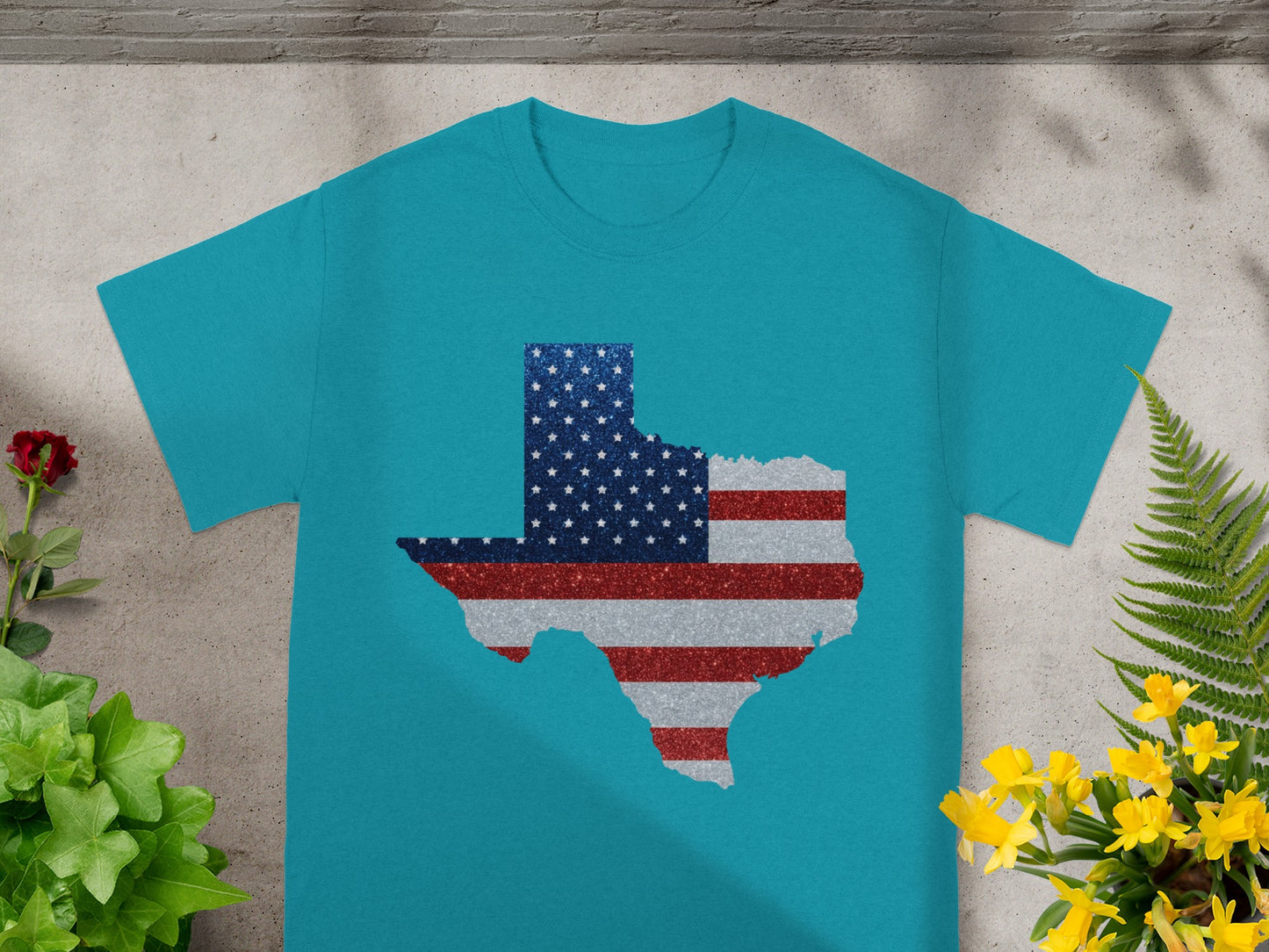 Turquoise t-shirt with a glittery Texas shape filled with the American flag design.
