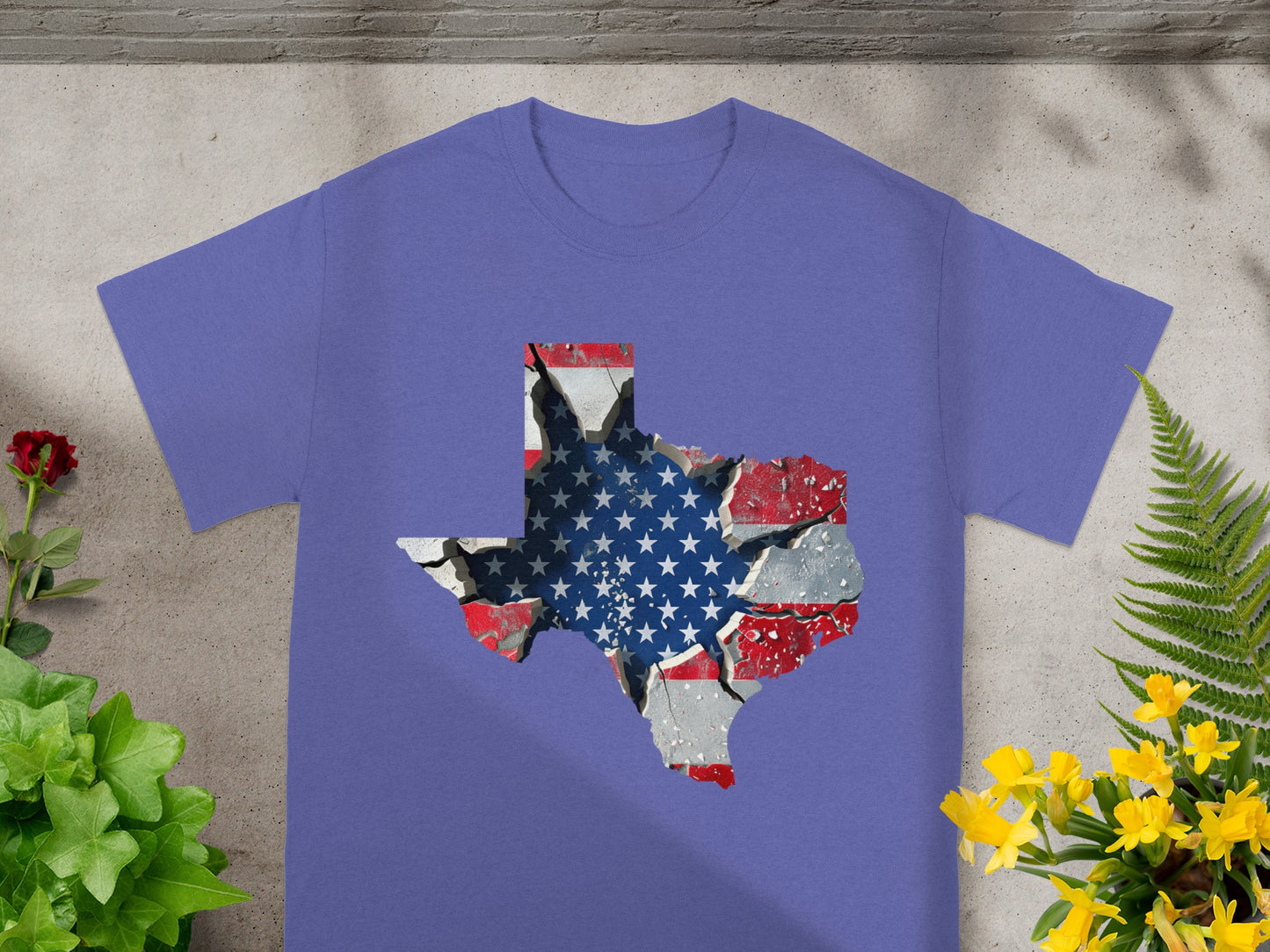 Purple t-shirt featuring a cracked Texas outline filled with the American flag design.