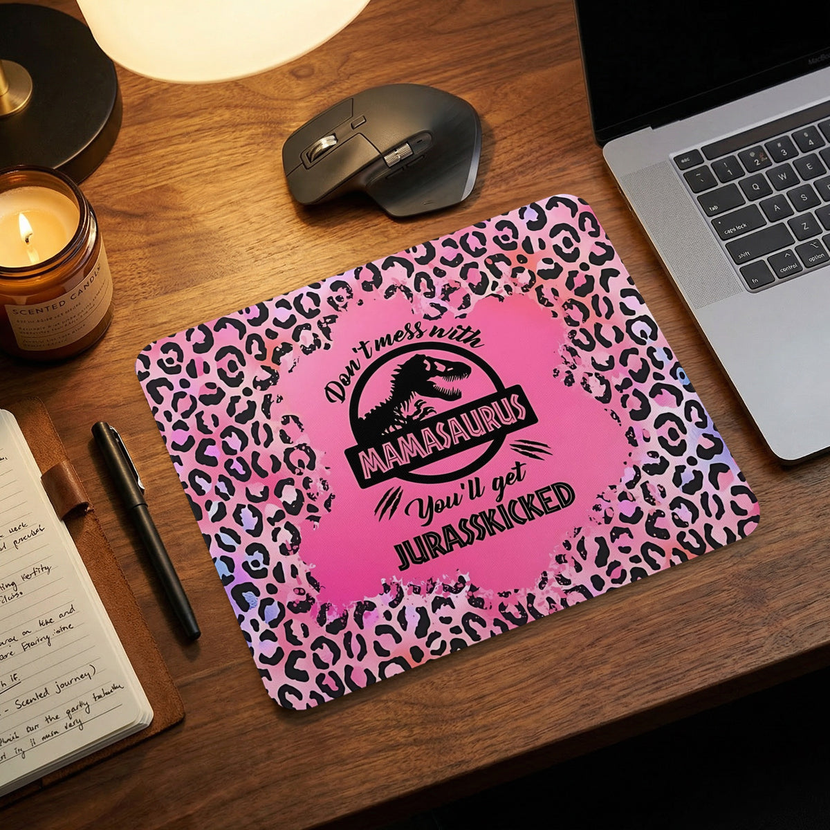 Pink leopard-print mousepad with text that reads Mamasaurus You will get Jurasskicked on a wooden desk.