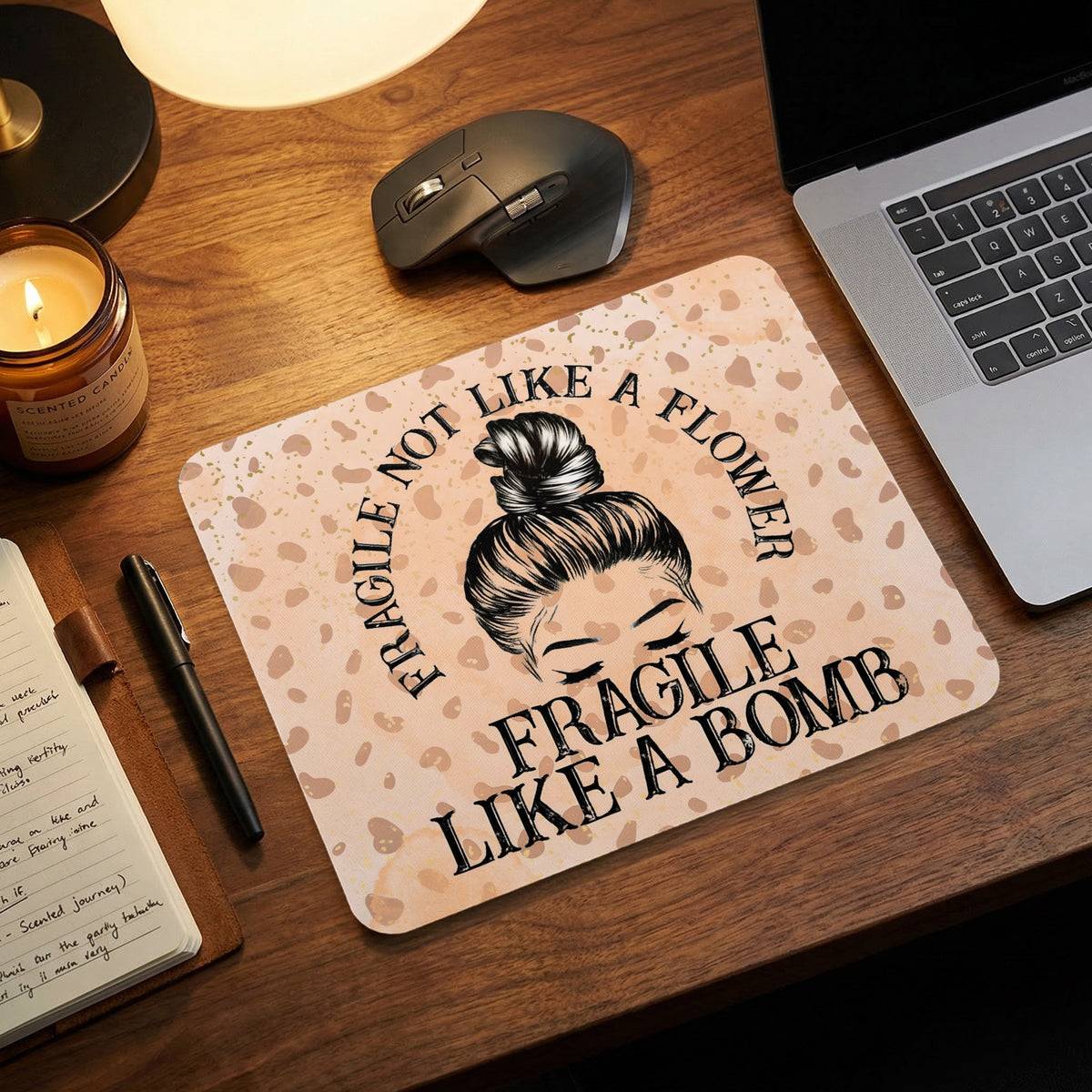 Mouse pad with a leopard print background featuring an illustration of a woman with a bun and the text Fragile Not Like a Flower Fragile Like a Bomb.