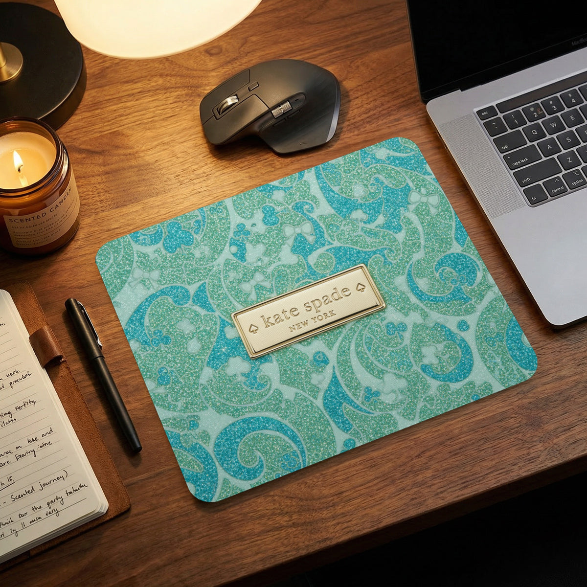 Kate Spade New York mousepad with a blue and green paisley glitter pattern.