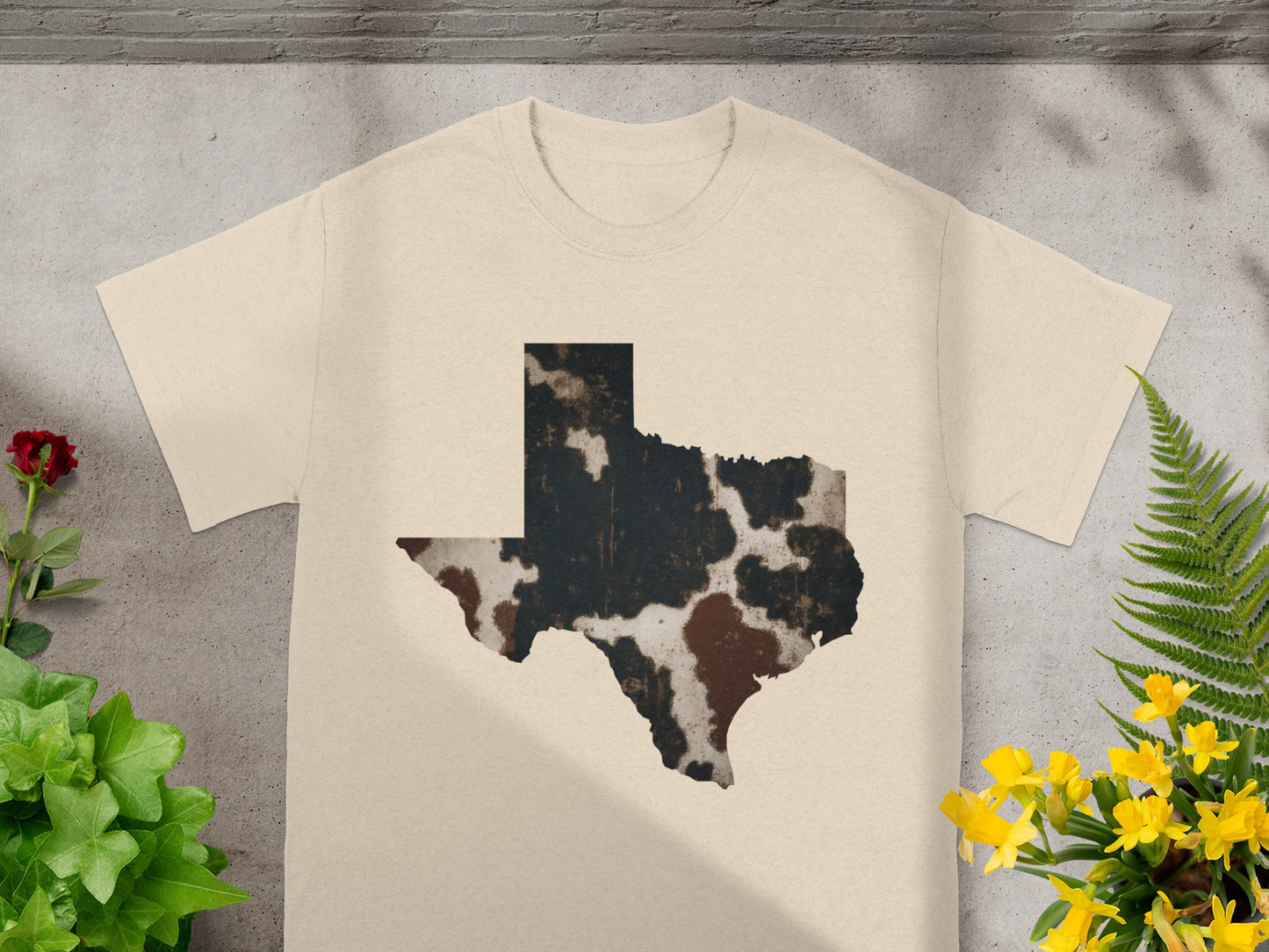 Cream t-shirt with a distressed cowhide print Texas outline.