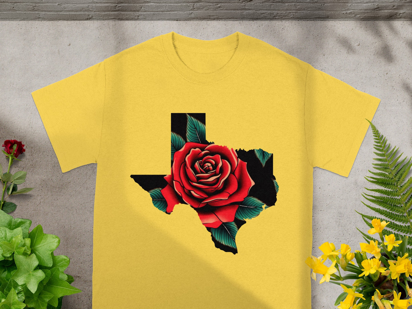 Yellow t-shirt with a Texas outline filled with a red rose and green leaves.