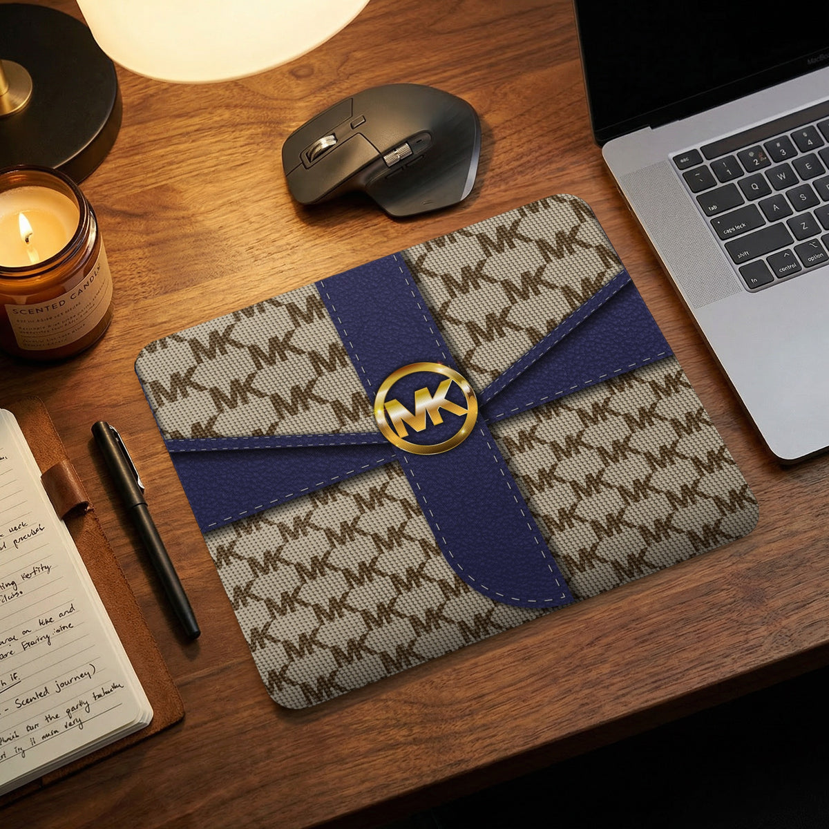 Michael Kors patterned mousepad with blue ribbon and gold logo.