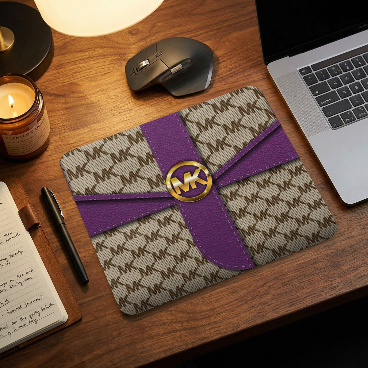 Michael Kors patterned mousepad with purple accents and gold logo.