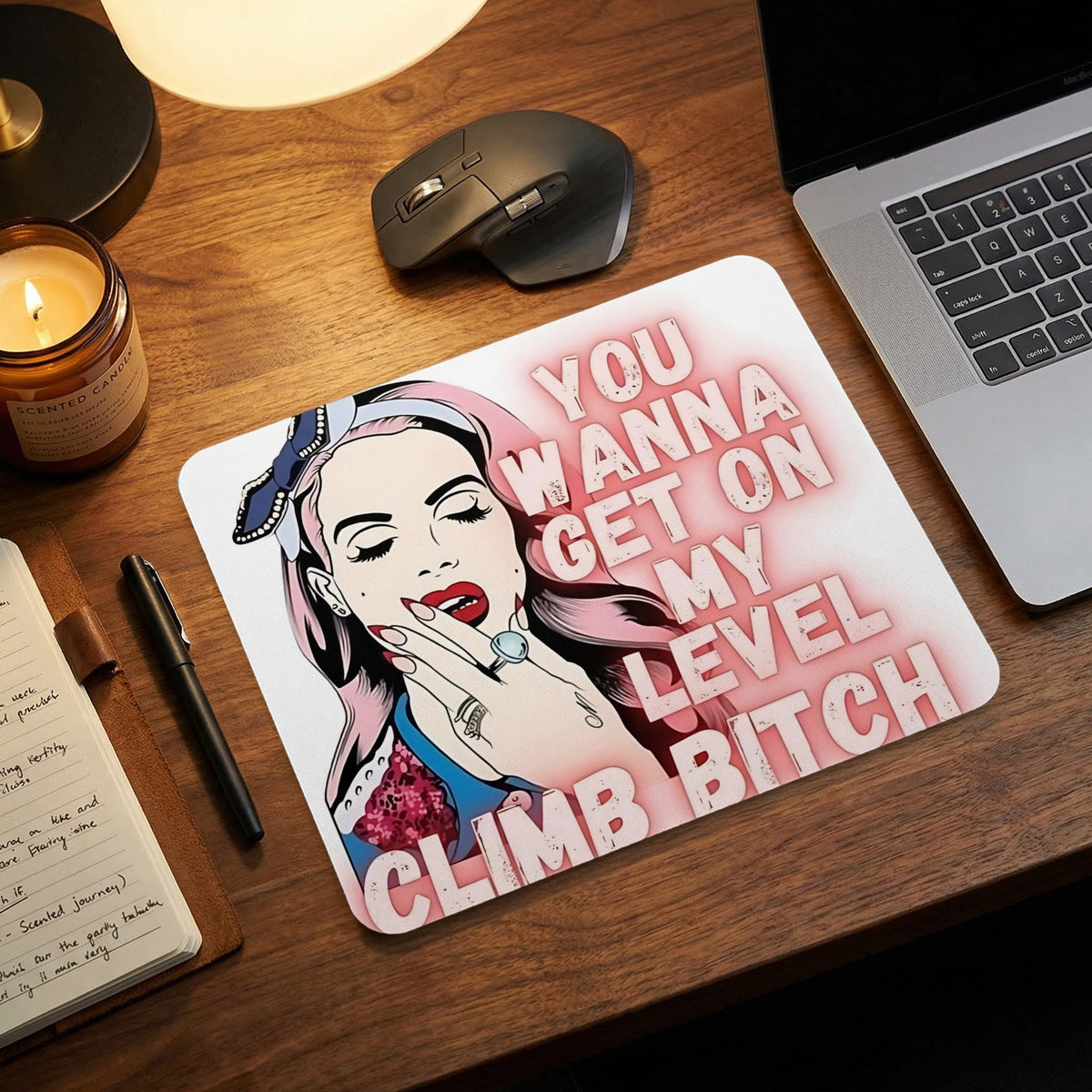 A mouse pad featuring a pop-art illustration of a woman with pink hair and the text YOU WANNA GET ON MY LEVEL CLIMB BITCH.